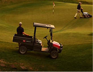 Man Riding a golf cart in golf field
