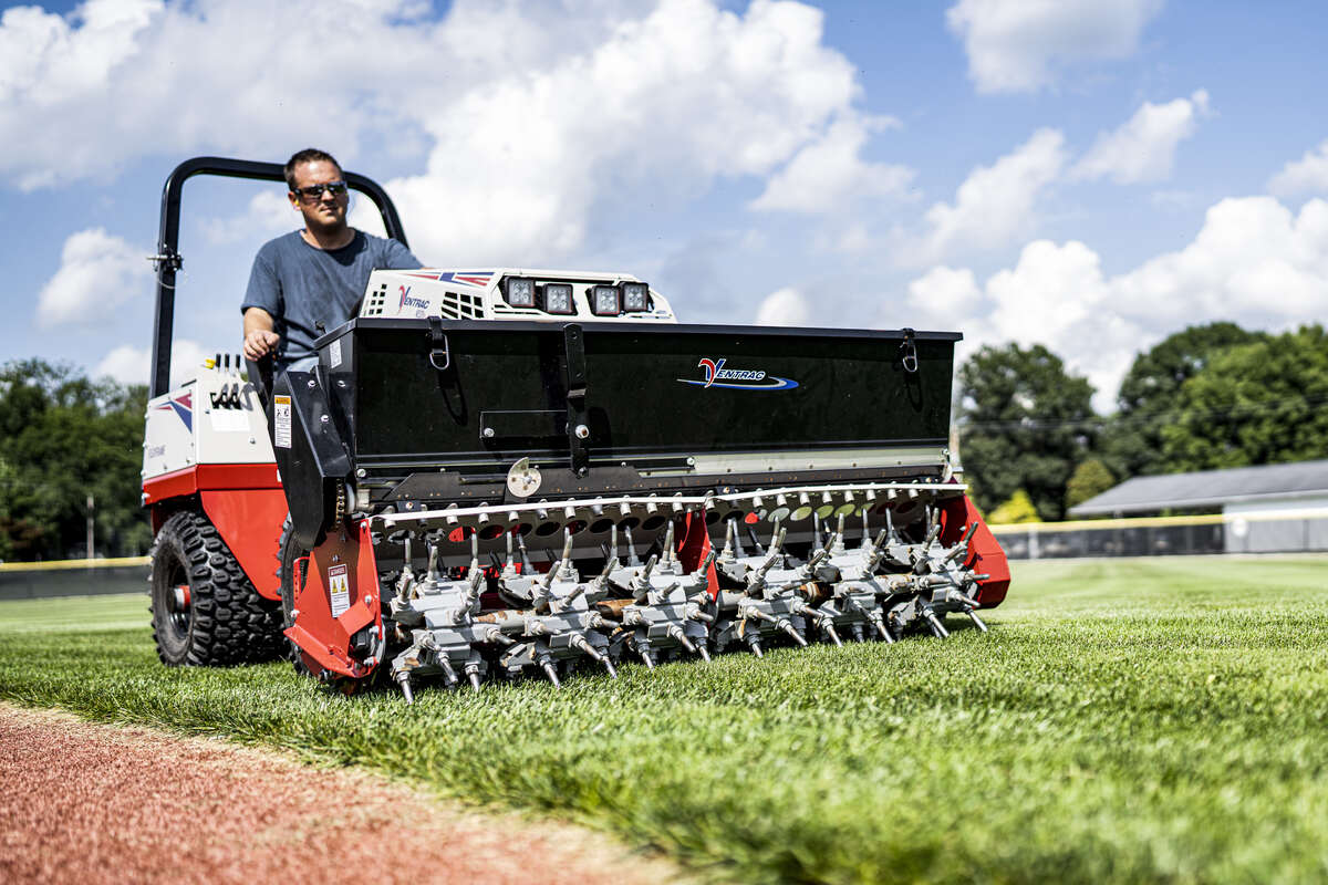 man using a Ventrac to mow the lawn